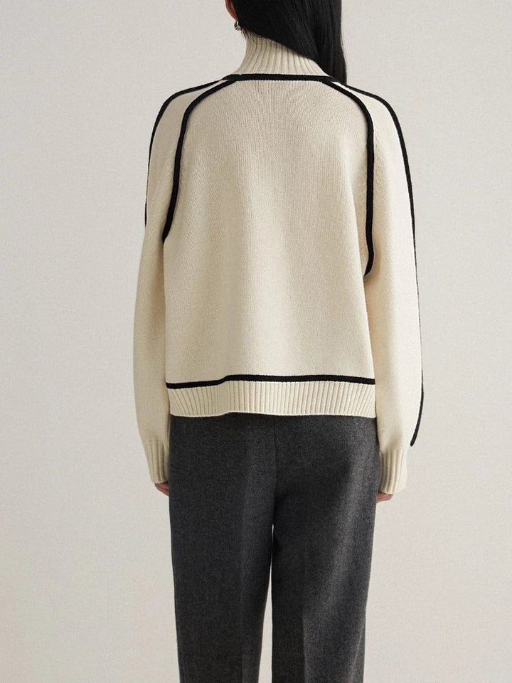 back view of cream oversized turtleneck sweater with black trim