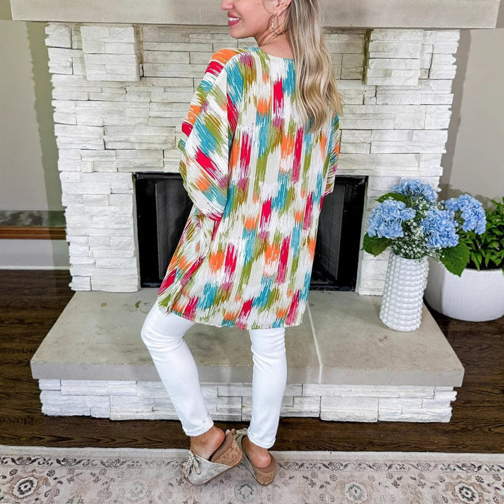 Back view of oversized abstract print tunic top with wide sleeves