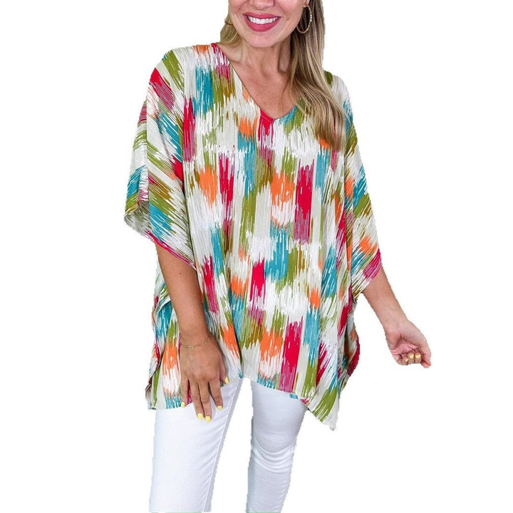 Multicolor abstract print kaftan top paired with white denim jeans