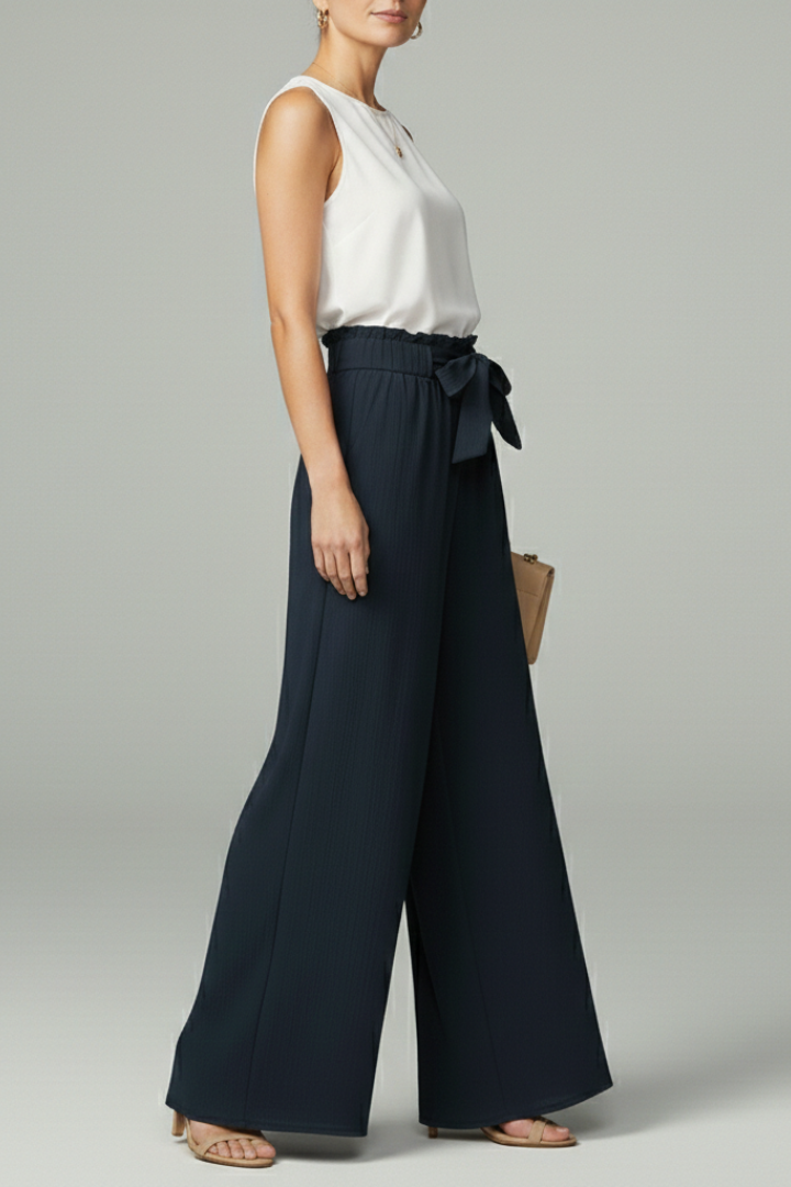 Side view of navy tie-belt palazzo trousers with wide flowy legs