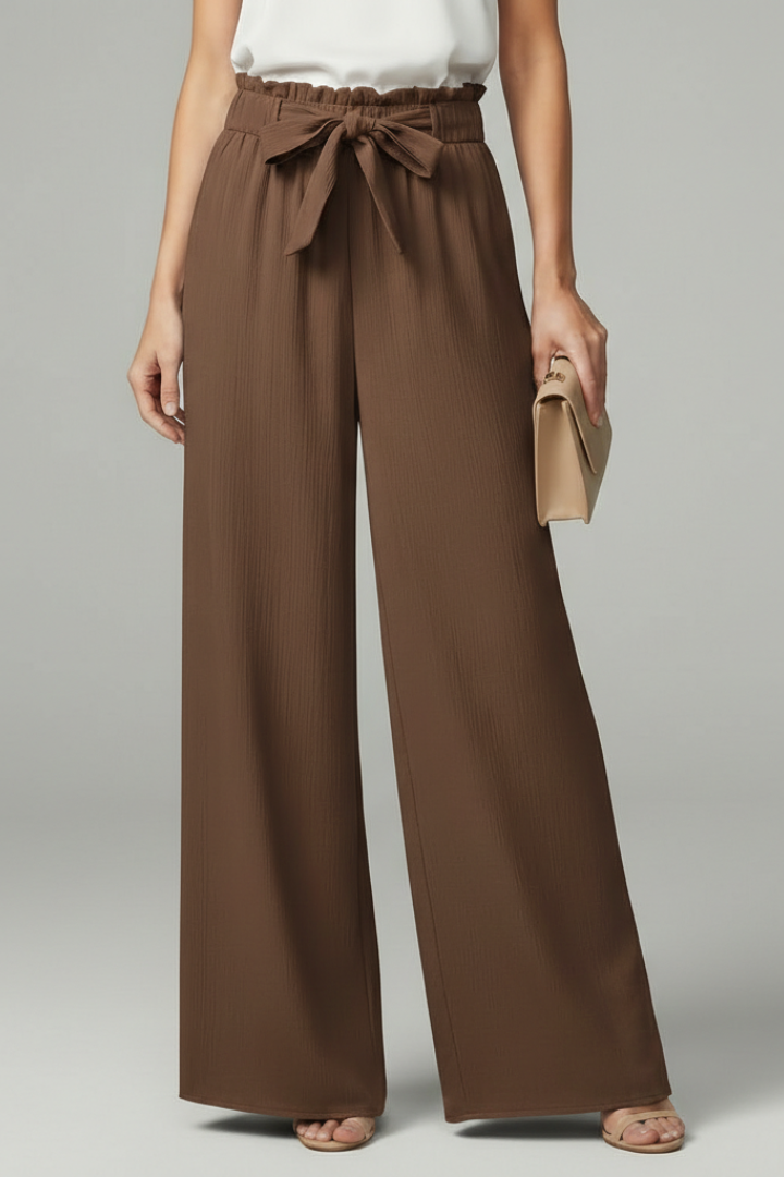 Model wearing brown wide-leg palazzo trousers with tie belt and paperbag waist