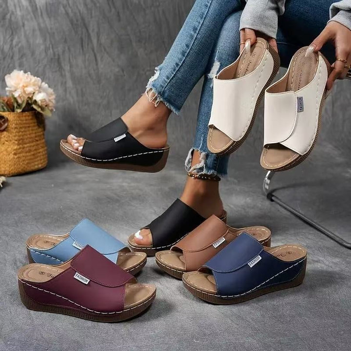 multiple color wedge sandals displayed together including navy, burgundy, and cream