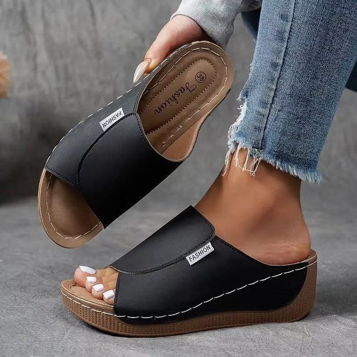 black open-toe wedge sandal with cushioned platform sole