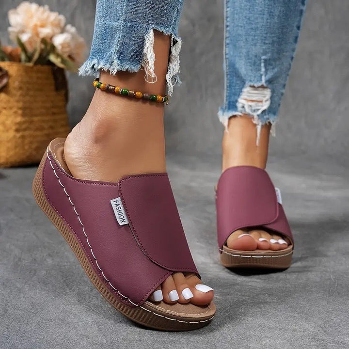 burgundy open-toe wedge sandal paired with distressed jeans and anklet