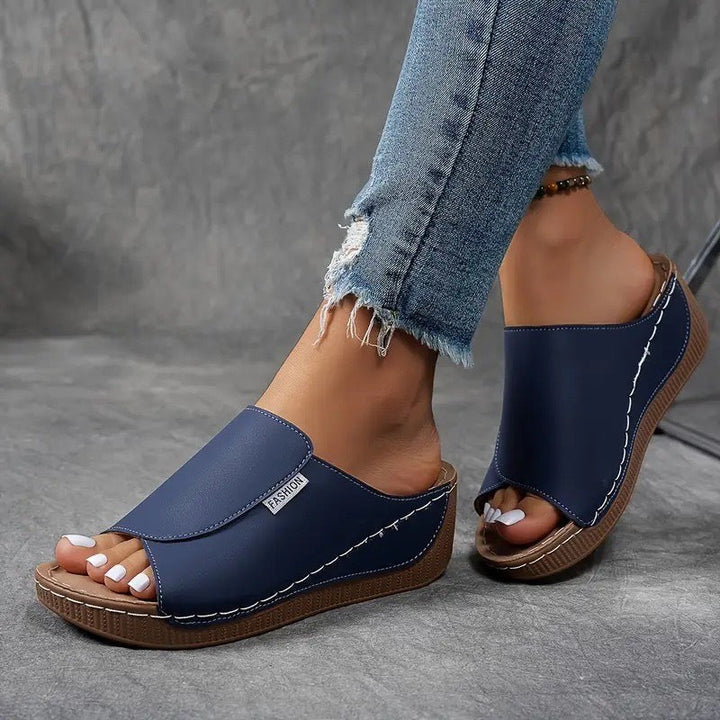 navy wedge sandal with crisscross strap and stacked platform sole
