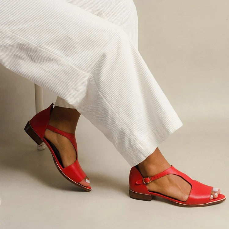 Red leather flat sandals with peep toe and ankle strap buckle detail