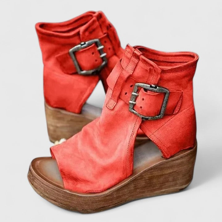 Red leather open-toe wedge boots with silver buckle strap and platform sole