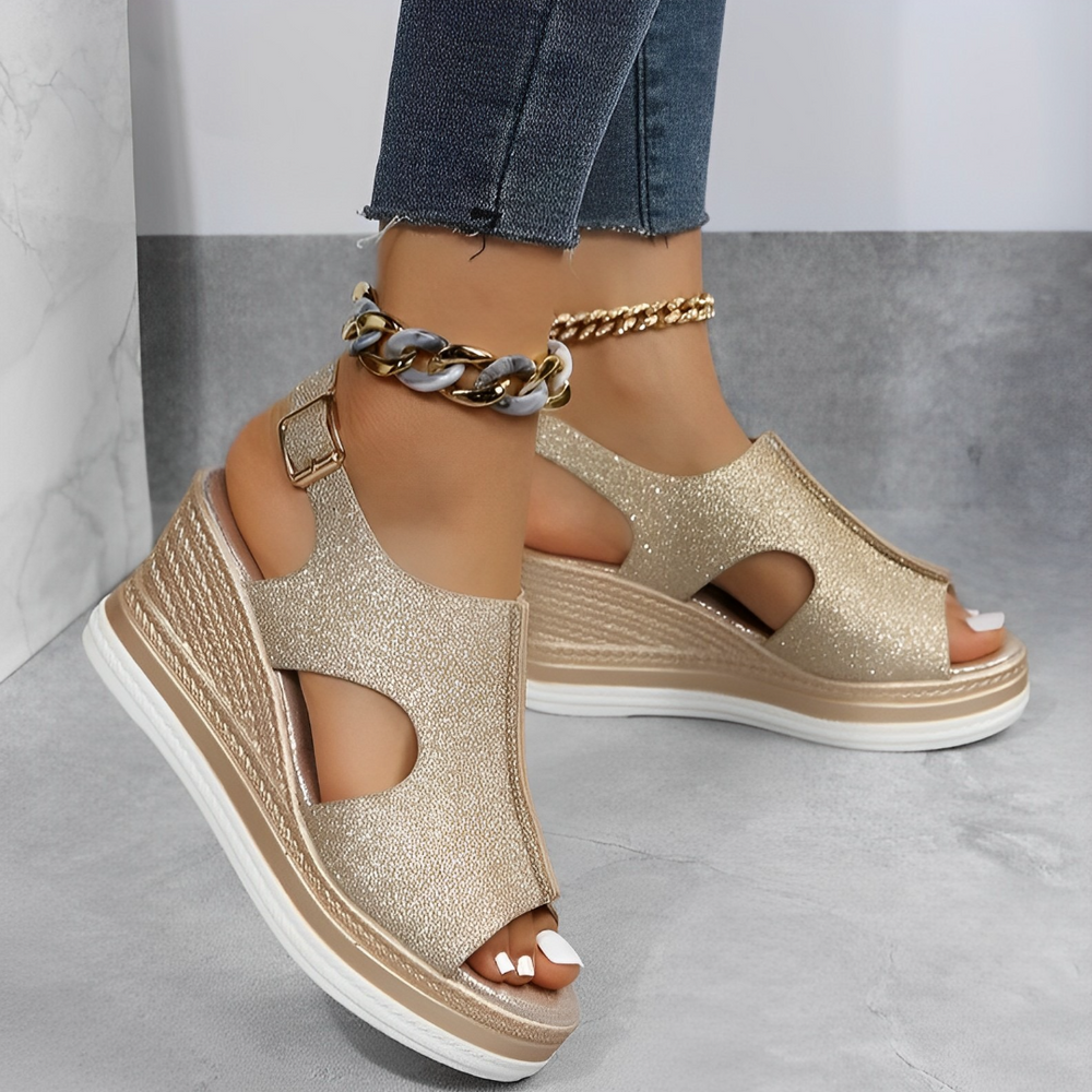 Gold glitter platform wedge sandals featuring peep toe and buckle strap