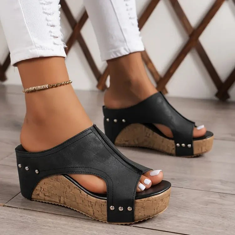 black peep-toe wedge sandals with studded straps and cork platform sole