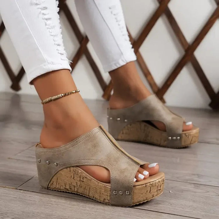 taupe suede wedge sandals featuring studded strap and cork sole