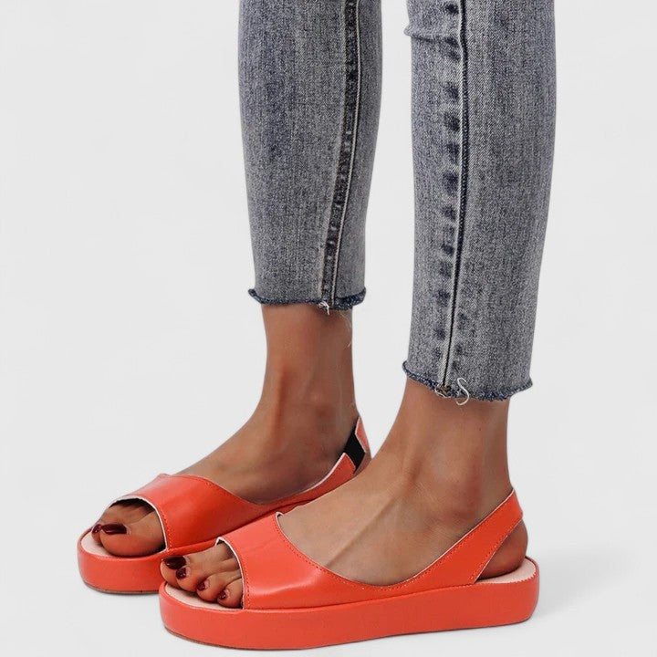 Orange slingback platform sandals styled with cropped gray denim jeans
