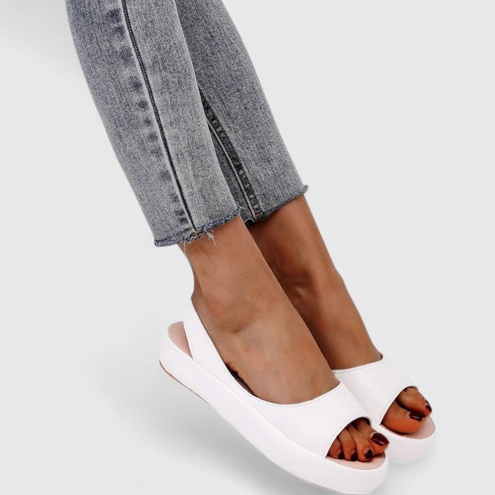 White slingback platform sandals with orthopedic sole shown on model