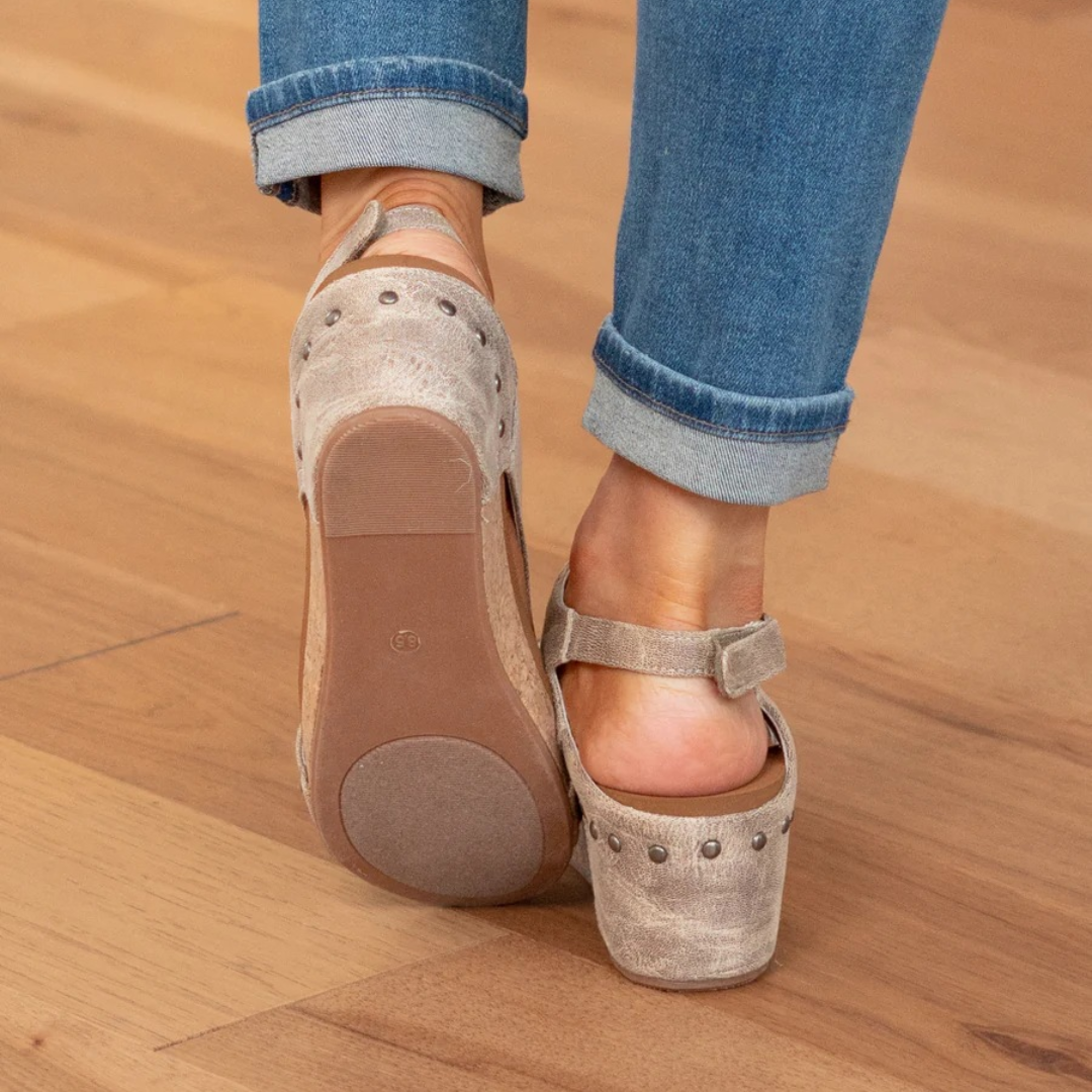 Back view of taupe suede wedge sandals showing rubber tread and cork wedge