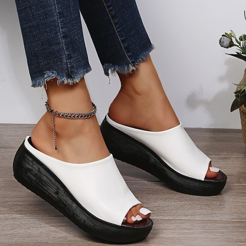 White peep-toe platform sandal featuring contrasting black wedge sole
