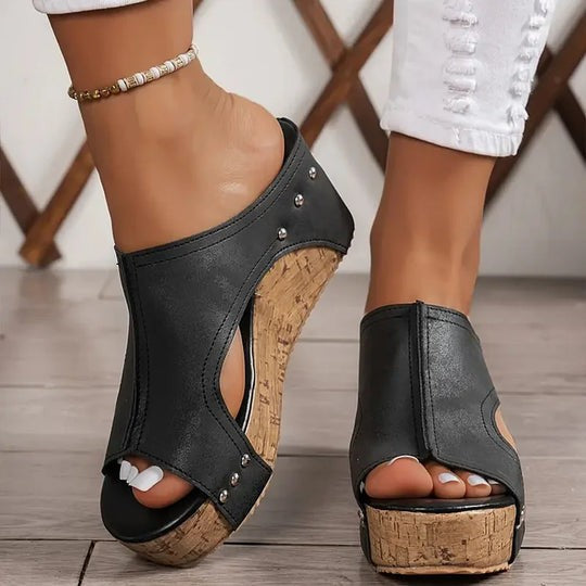 studded black wedge sandal showing peep-toe and cork sole detail
