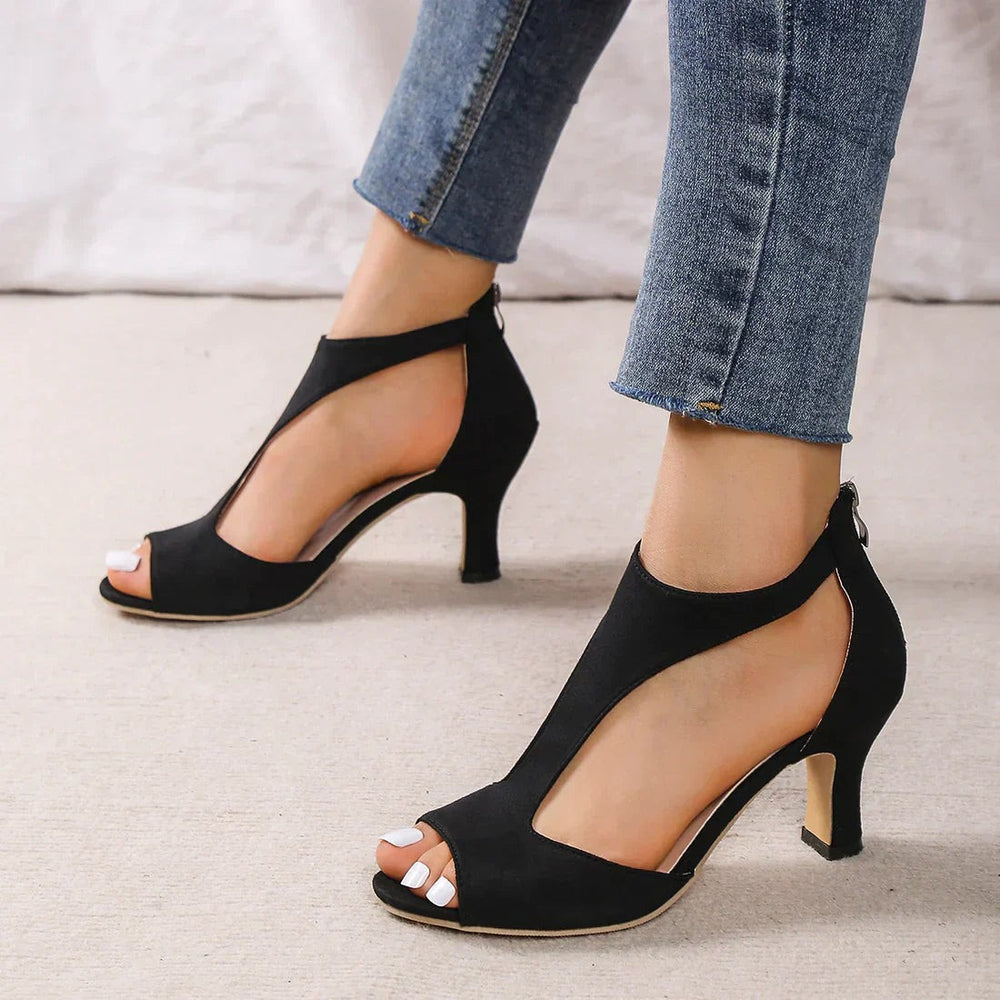Black suede peep-toe sandal featuring T-strap cutout and back zipper closure