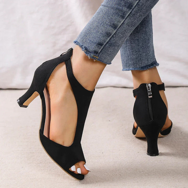 Black suede low heel sandal showing back zipper and open T-strap sides