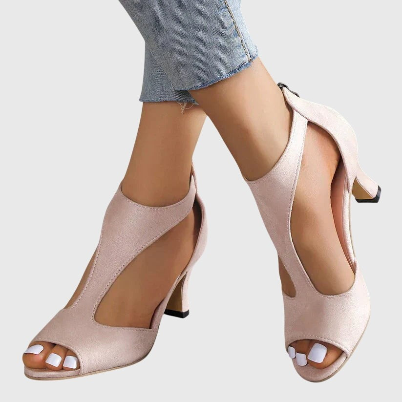 Blush suede peep-toe heels with cutout T-strap design and back zipper