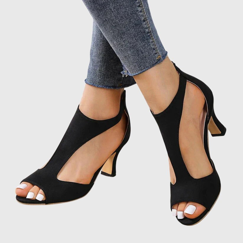 Black suede peep-toe heels with T-strap cutout and stiletto heel