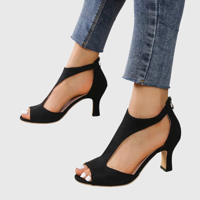 Black suede open-toe heels with curved side cutout and mid heel