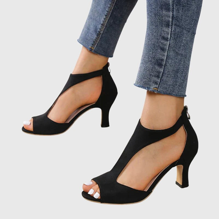 Black suede open-toe heels with curved side cutout and mid heel