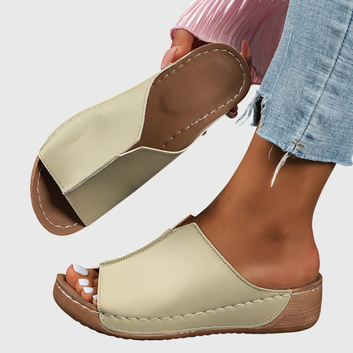 Beige peep-toe wedge sandal with visible stitched seams