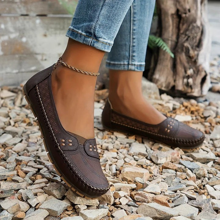 dark brown loafers worn outdoors with anklet and stitched leather trim