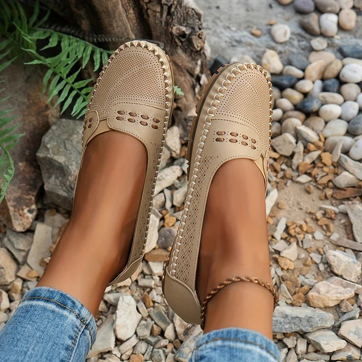 tan perforated slip-on shoes with cutout accents and flexible sole
