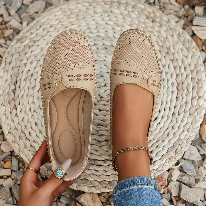 beige perforated leather loafers with hand-stitched trim and cushioned insole