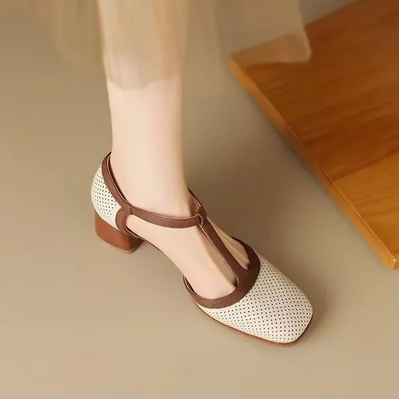 square toe T-strap block heel shoe worn on foot near wooden bench