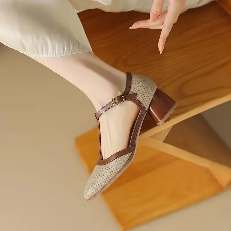 close-up of brown buckle strap on beige perforated block heel pump