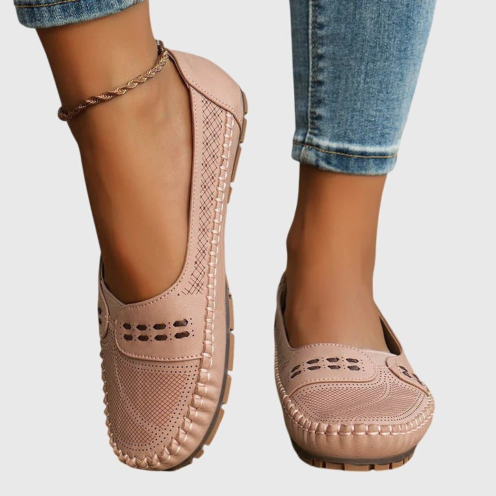 Blush pink perforated leather flats worn with cuffed denim