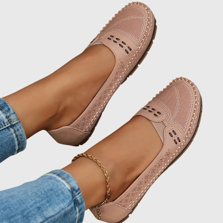 Pink leather slip-on shoes with scalloped stitching, top view