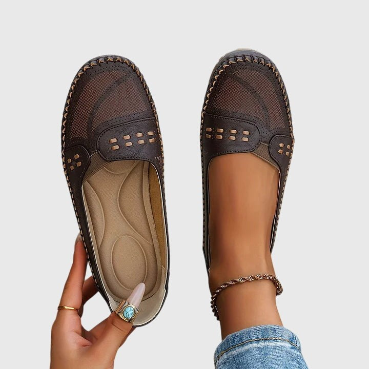 Dark brown perforated leather flats with contrast stitching detail