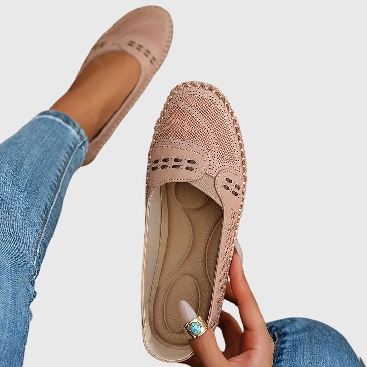 Blush pink leather slip-ons with perforated design and scalloped edge