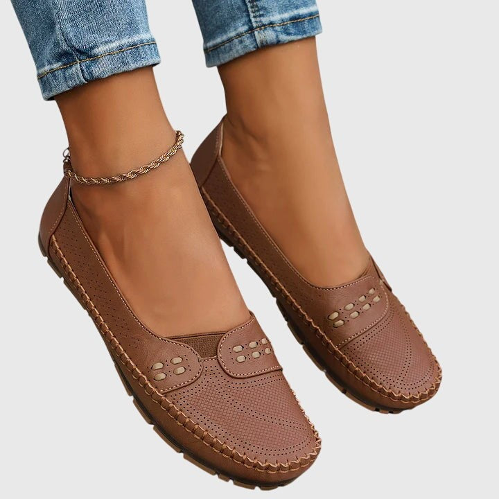 Camel leather slip-on flats displayed on foot with gold anklet