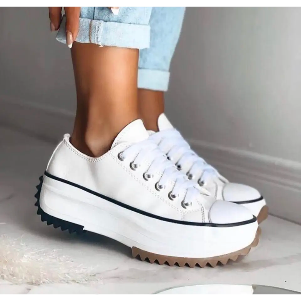 White canvas platform sneakers with lace-up front and toothed gum sole
