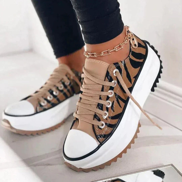 Zebra print platform sneakers with tan accents and chunky white midsole