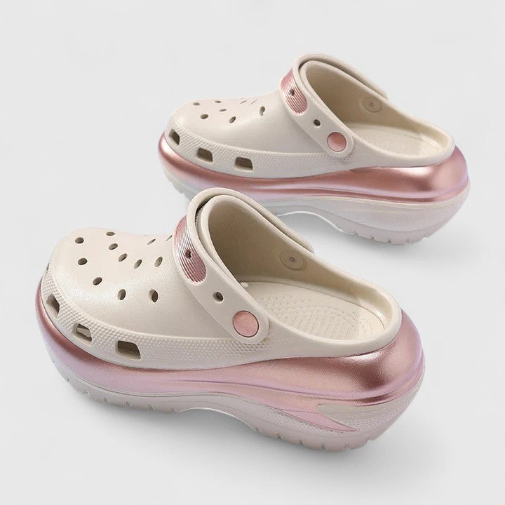 Cream platform clogs with metallic rose gold trim and chunky sole