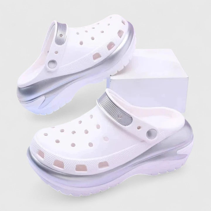 White platform clogs featuring iridescent silver trim and thick sole