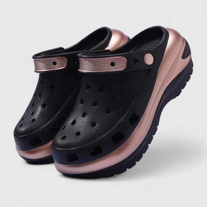 Black platform clogs with rose gold trim and thick lugged sole