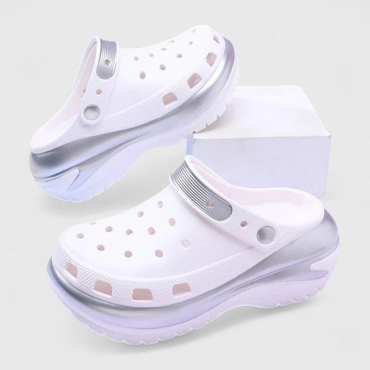 White chunky clogs with iridescent silver detailing and thick platform sole