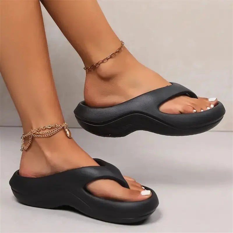 black platform flip flops with thick cushioned sole and thong toe strap