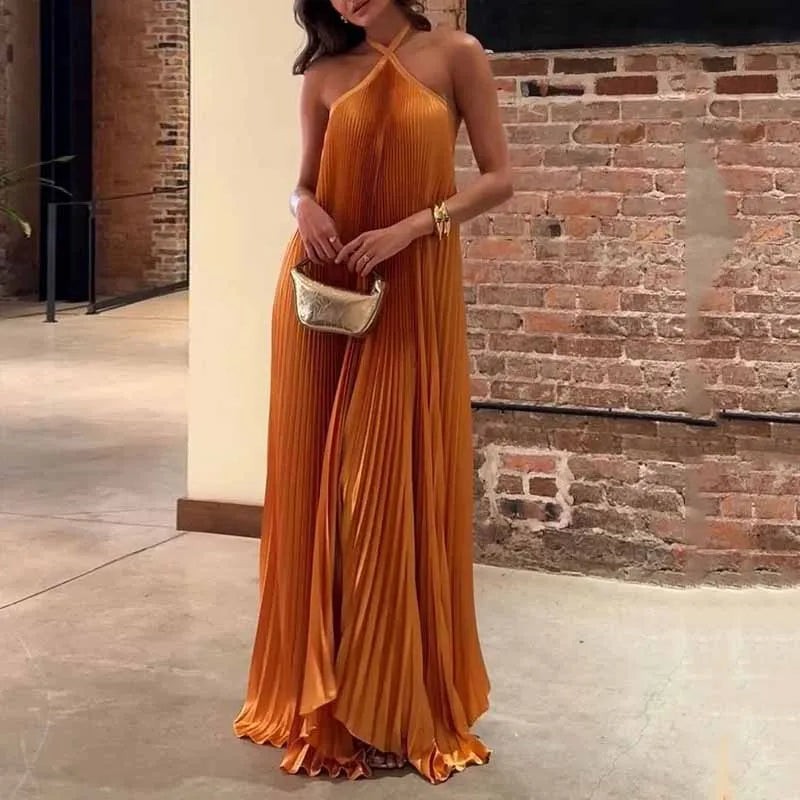 Orange pleated halter maxi dress with flowing satin skirt for evening wear