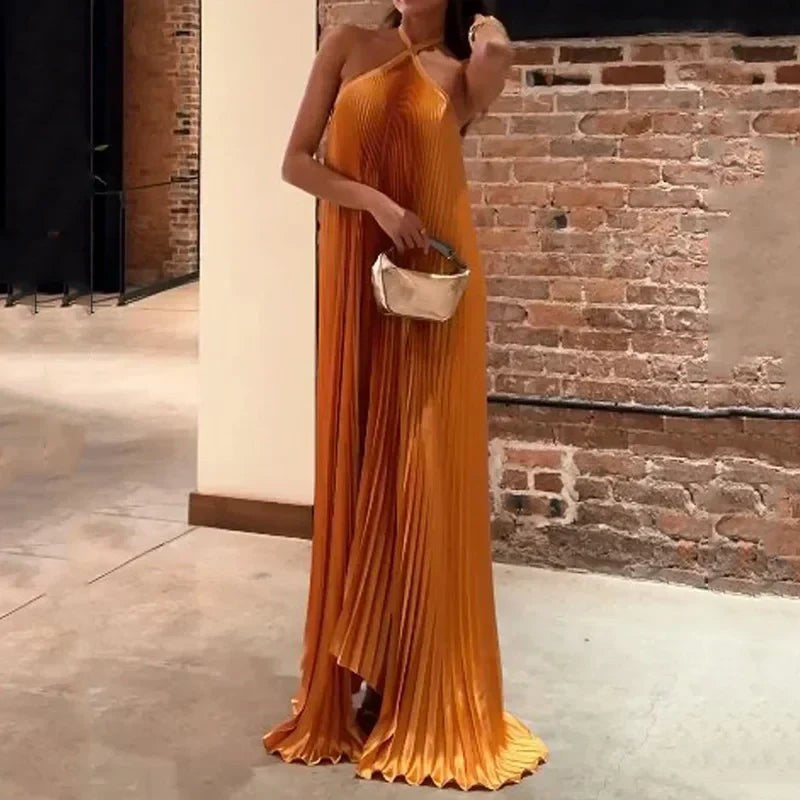 Flowy pleated evening gown in orange satin with crisscross halter neckline