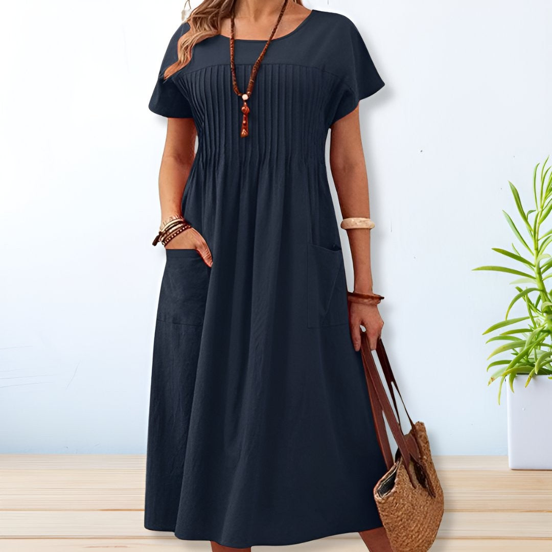 Navy blue pintuck midi dress with short sleeves and relaxed A-line fit