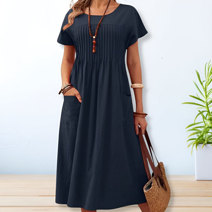 Navy blue pintuck midi dress with short sleeves and relaxed A-line fit