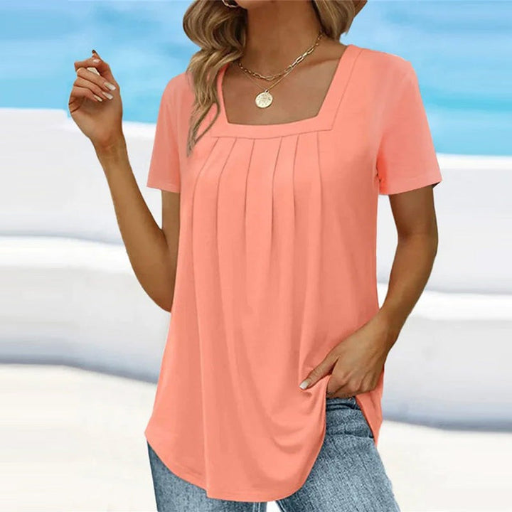 Coral pleated square-neck blouse paired with denim jeans
