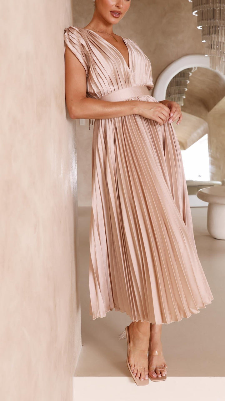 Side view of blush pink pleated satin dress with elastic waistband