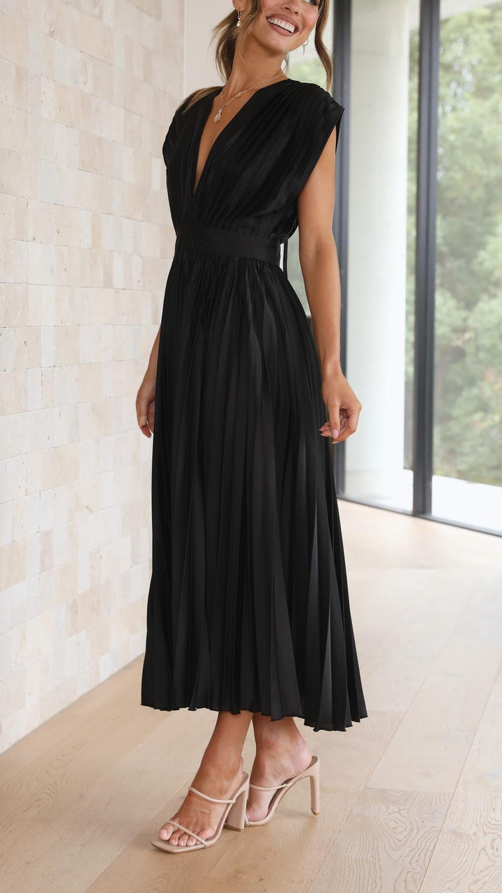 Back view of black pleated satin dress with open tie-back neckline